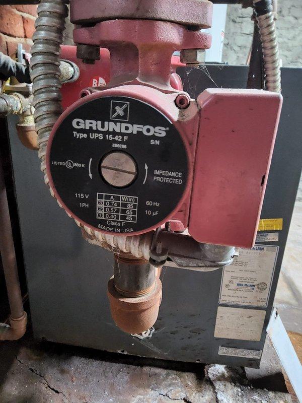 Conducted estimate for boiler replacement in basement mechanical room. Assessed existing system including blue-gray boiler unit, Grundfos UPS 15-42 F circulation pump (115V, 1PH, 60 Hz), copper piping network with shutoff valves, galvanized expansion tank, and associated hydronic heating components. Documented current equipment condition and photographed installation for replacement specifications.