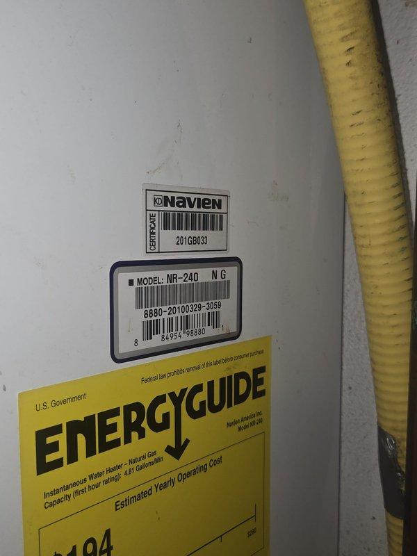 Conducted on-site assessment of existing Navien NR-240 NG tankless water heater in mechanical room to provide replacement estimate. Inspected unit with front panel open to evaluate internal components, circuit boards, wiring, and copper piping connections. Documented current installation including water filtration system, gas line configuration, and venting requirements for replacement specifications.