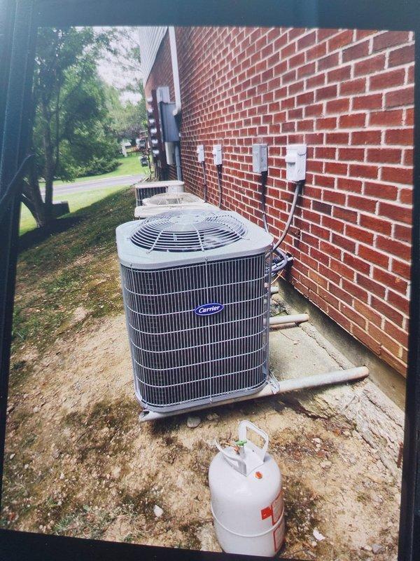 Completed commercial HVAC installation of Bryant GA4SAN52400N 2-ton 14 SEER condenser with R-454B refrigerant and CVAVA2417 evaporator coil. Flushed and reused existing refrigerant lines, fabricated and installed sheet metal connections to existing supply and return ductwork, and installed outdoor disconnect with whip, pad, and fuses. System tested and operational with proper refrigerant charge confirmed at service valves.