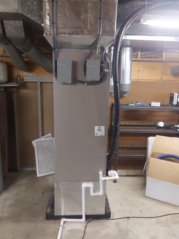 Completed full HVAC system installation including 37MUHAQ36AA3 ductless outdoor unit mounted on concrete pad with support poles, FT5ANXC36L00 R454B fan coil air handler with integrated filter rack, and TU-EC-15BKB 15kw auxiliary heat kit. Installed approximately 20 feet of refrigerant lineset, ran new high voltage electrical service to outdoor condenser with disconnect box and fuses, and built partial return air drop with return box. Added APCO-X air treatment system with UV light for enhanced indoor air quality, replaced existing thermostat with Bryant Ecobee 3 with Intelisense Lite Pro wifi-enabled unit for remote control and monitoring, and capped existing water line to water heater. System tested and operational upon completion.