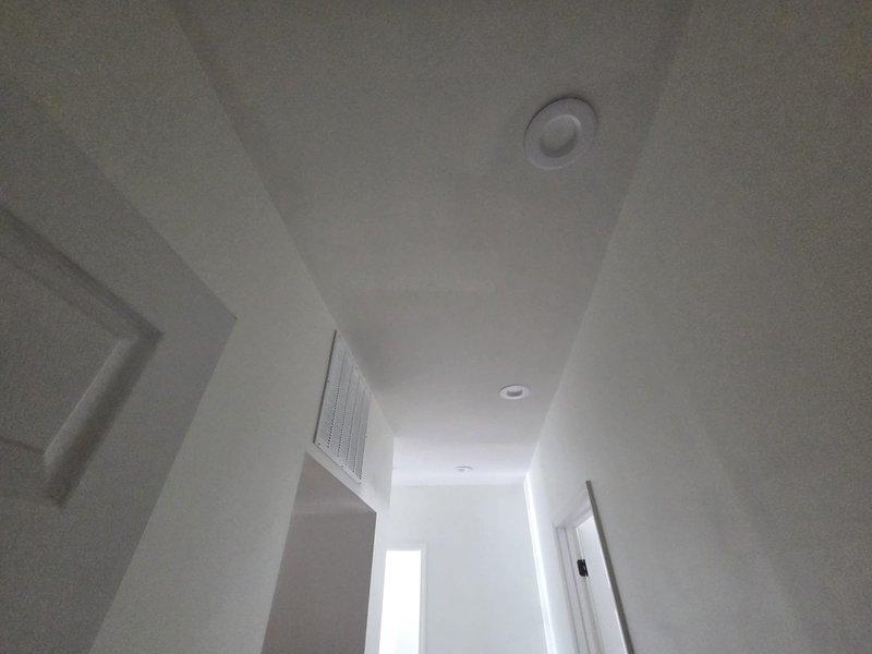 Conducted comprehensive on-site assessment for complete HVAC system replacement including ductwork modifications, air conditioning unit, and gas furnace installation. Evaluated existing ventilation infrastructure throughout residential interior, documented current ceiling-mounted supply registers and return air grilles, and photographed entryway conditions to determine optimal equipment placement and duct routing for new system installation.