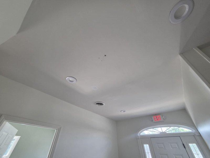 Conducted comprehensive on-site assessment for complete HVAC system replacement including ductwork modifications, air conditioning unit, and gas furnace installation. Evaluated existing ventilation infrastructure throughout residential interior, documented current ceiling-mounted supply registers and return air grilles, and photographed entryway conditions to determine optimal equipment placement and duct routing for new system installation.