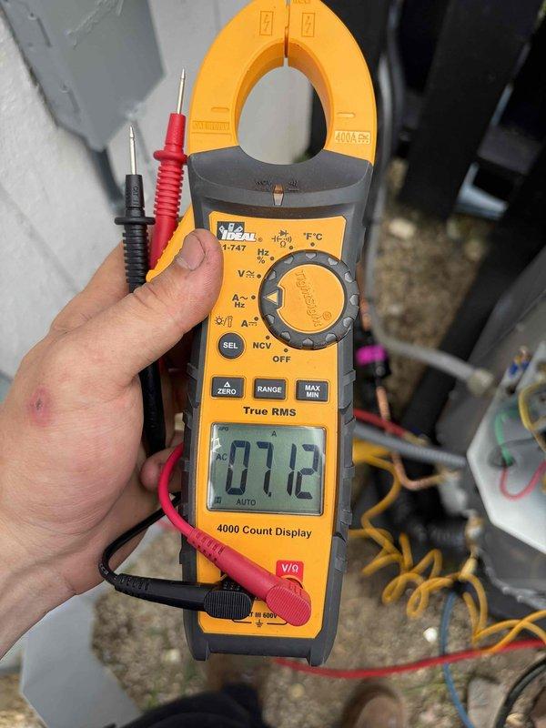 Replaced condenser unit under warranty at commercial facility. Verified electrical readings with clamp meter showing 7.12A and 24.23A on respective circuits, confirming proper amperage draw and system operation upon completion.