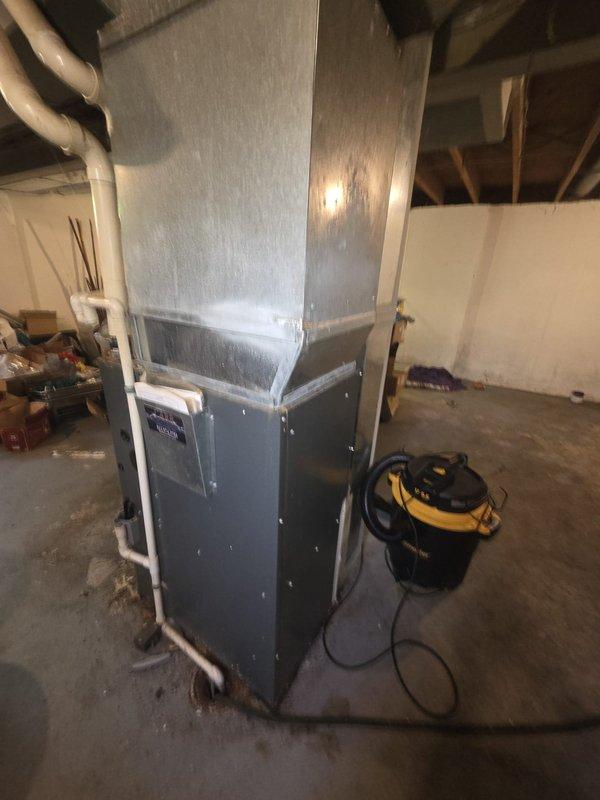 Completed comprehensive HVAC system replacement estimate for residential property. Evaluated existing outdoor condenser unit located on concrete pad adjacent to building exterior and indoor furnace system in basement utility area. Assessed both components for replacement recommendations, documenting current equipment condition, installation configurations, and necessary specifications for complete system upgrade.