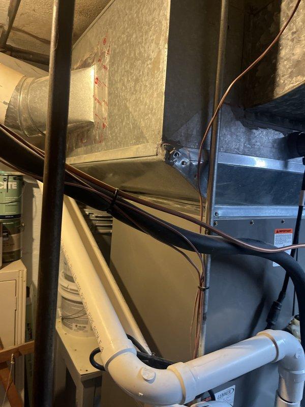 Completed estimate for full HVAC system replacement at residential property. Evaluated existing Lennox outdoor condensing unit located on concrete pad adjacent to brick exterior wall and assessed indoor air handler with associated refrigerant lines, PVC condensate drainage system, and ductwork in mechanical space. Documented current system configuration including copper line sets, drainage components, and equipment placement for replacement proposal.