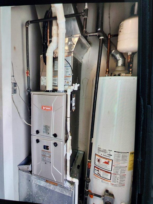 Completed full HVAC system replacement at commercial apartment facility, installing Bryant GA4SAN52400N 2-ton 14 SEER condenser with R-454B refrigerant, Bryant 912SE36040 90% gas furnace, and CVAVA2414 evaporator coil in mechanical closet. Flushed and reused existing refrigerant lines, fabricated sheet metal connections to integrate with existing supply and return ductwork, and installed outdoor disconnect with whip, pad, and fuses. System commissioned with verified amperage draw of 8.645A, all equipment operational and permit obtained.