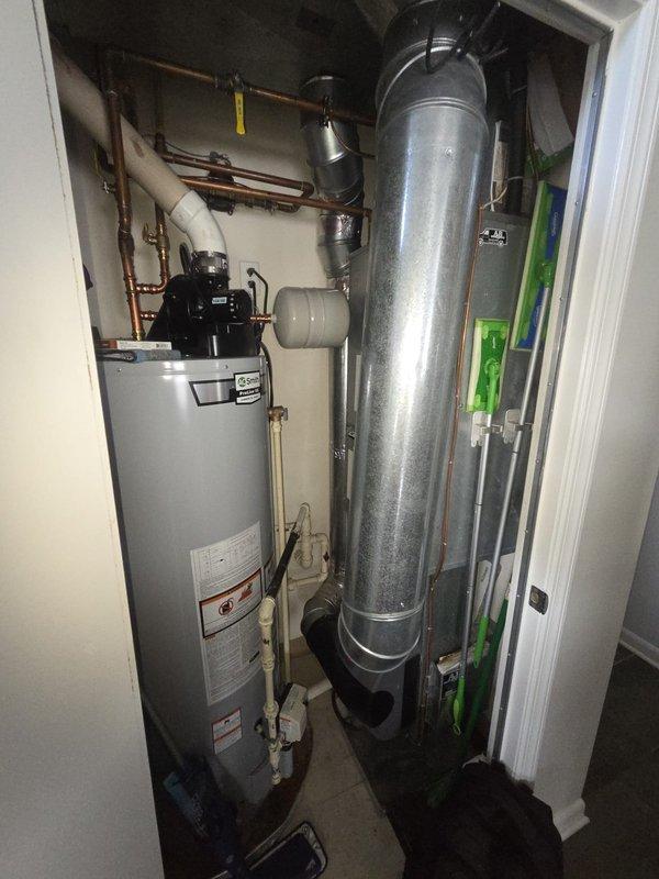 Completed system replacement in mechanical utility closet. Removed existing HVAC equipment and installed new heating system components including water heater with integrated pump assembly and expansion tank with associated plumbing connections. Configured copper piping, PVC connections, and flexible ductwork to ensure proper system integration and code compliance.