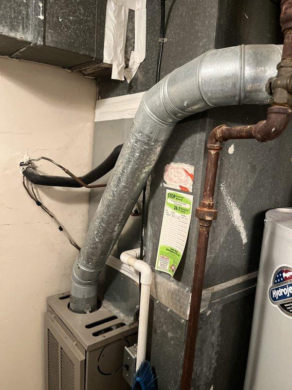 Performed comprehensive assessment of aging commercial R-22 HVAC system experiencing inadequate cooling capacity. Evaluated outdoor condensing unit positioned against building exterior and inspected indoor air handling components in basement mechanical room. System currently operational but unable to maintain desired temperature setpoints due to obsolete refrigerant technology and equipment age. Documented existing equipment configuration including outdoor unit with deteriorating housing, electrical disconnect, and indoor ductwork with visible condensation issues. Provided detailed replacement estimate for complete system upgrade to modern, efficient equipment compatible with current refrigerant standards to restore proper cooling performance and ensure regulatory compliance.