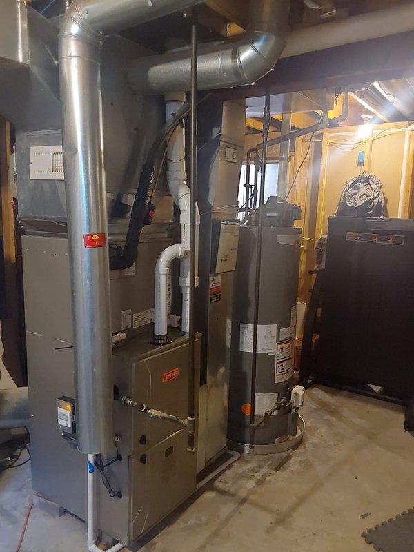 Completed full HVAC system installation including Bryant 926TC60100V21 96% AFUE variable-speed two-stage gas furnace with constant torque ECM motor, Bryant 146SAN04200W 3.5-ton single-stage air conditioner utilizing R454B refrigerant, and CVAVA4221XMA cased vertical V-coil evaporator coil. Installed outdoor condensing unit on ground-level pad with proper electrical disconnect and conduit connections to existing meter base, positioned furnace in basement mechanical room with vertical supply ductwork and flexible return connections, mounted evaporator coil to furnace plenum, completed all refrigerant line sets between indoor and outdoor components, verified proper electrical connections and system startup, tested all safety controls and operational sequences across both heating and cooling modes.