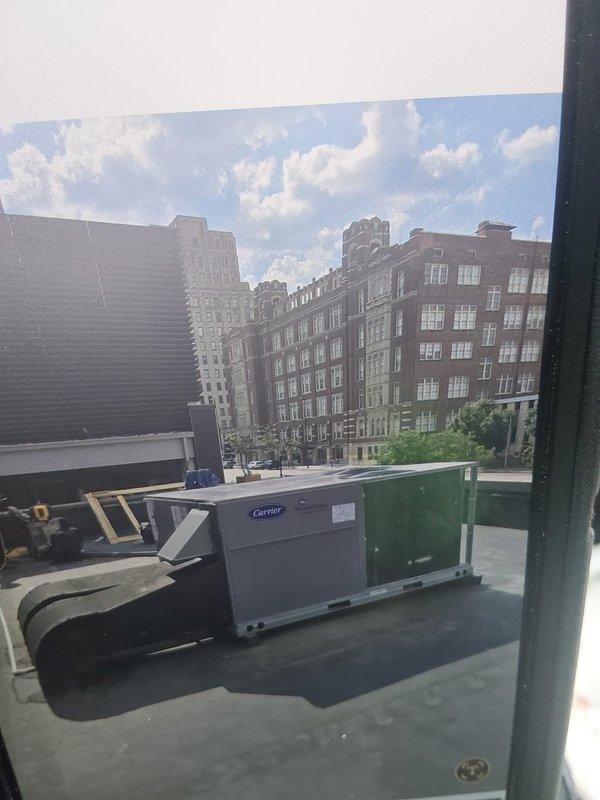 Installed 7.5-ton commercial rooftop unit (48FEEM08A2A5-0A0A0) with two-stage cooling, medium gas heat capability, 208/230V 3-phase power, vane axial fan, and electro-mechanical controls featuring aluminum/copper condenser and evaporator coils. Coordinated crane service for rooftop placement, field-installed manual outdoor air damper (MM-OAM-TC712-CD), completed electrical connections with conduit runs, and installed customer-provided SENSI thermostat control. Removed existing boiler system as part of HVAC conversion project; gas line hookup deferred pending availability of gas service connection.