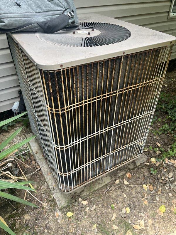 Provided estimate for complete heat pump system replacement of 1994 unit utilizing obsolete R22 refrigerant that is no longer adequately maintaining temperature. Existing outdoor condenser unit shows significant age-related deterioration with rust staining and weathering on cabinet panels, and electrical panel is Federal Pacific Stab-Lok series requiring updating to current safety standards.