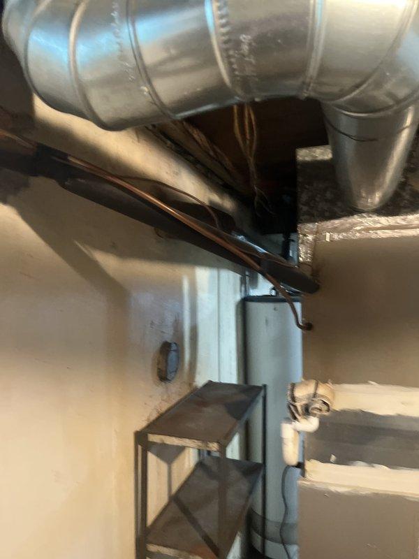 Conducted comprehensive assessment of existing HVAC system in basement mechanical room for complete system replacement. Evaluated current furnace unit, ductwork configuration, and associated mechanical components to provide detailed replacement estimate. Documented existing equipment condition, duct layout with galvanized metal runs, copper refrigerant lines, and electrical connections to determine proper sizing and installation requirements for new system.
