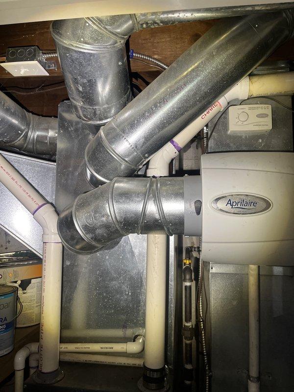 Conducted comprehensive HVAC system evaluation for replacement estimate at residential property. Assessed existing Goodman furnace installation including connected ductwork, plenum configuration, Aprilaire humidifier unit, PVC condensate drainage system, and flexible metallic supply ducts. Documented current equipment specifications, installation conditions, and system components through detailed photography to provide accurate replacement recommendations and ensure proper sizing for new equipment installation.