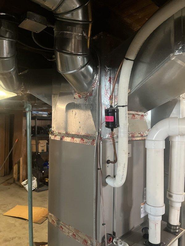 Completed estimate for complete HVAC system replacement in basement utility room. Assessed existing furnace/air handler unit with associated metallic ductwork, including vertical and horizontal trunk lines with sealed seams and insulation. Evaluated PVC condensate drainage system and existing duct configuration with exposed joists in unfinished basement space. Documented current equipment condition, ductwork layout, and mechanical components to provide comprehensive replacement proposal for new HVAC system installation.