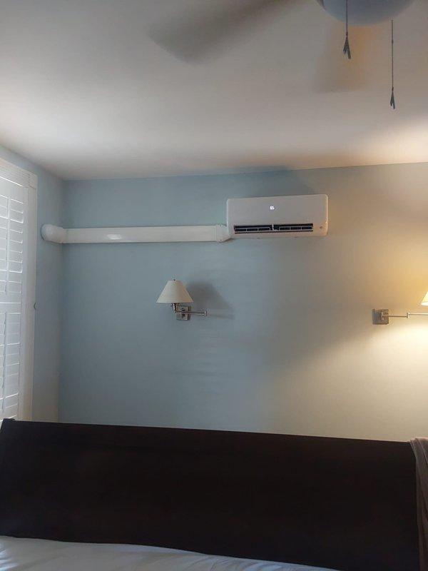 Installed a complete 27 SEER2 12,000 BTU single-zone ductless mini split system consisting of model D5MAHAQ12XA3 indoor high-wall unit and 37MAHAQ12AA3 outdoor heat pump. The indoor head was mounted on the second-floor bedroom wall above the bed, while the outdoor unit was positioned on a new equipment pad with snow legs in front of the glass block window on the side of the home. Ran refrigerant lineset vertically from the outdoor unit up the exterior wall and into the second-floor bedroom, with line hide installed on both exterior and interior walls for a clean finished appearance. Installed new high-voltage electrical service from the main panel through the basement to the outdoor unit location, including a new disconnect box with fuses for code compliance and proper system protection.