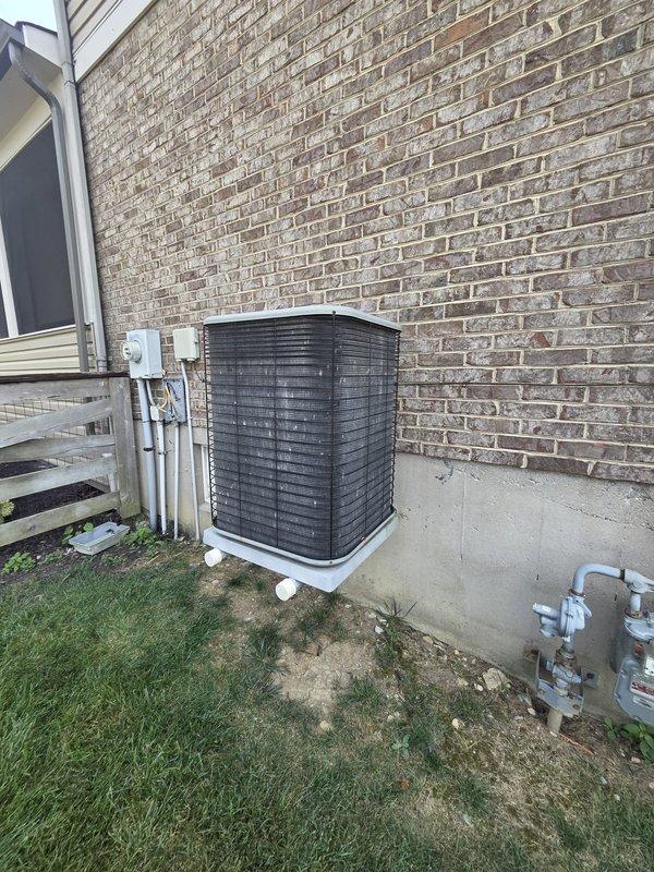 Completed comprehensive equipment evaluation for nearly 20-year-old residential HVAC system including gas furnace and air conditioning condenser unit. Customer requesting Carrier brand replacement options for aging system approaching end of expected service life.

Inspected exterior AC condenser unit with horizontal louvers positioned on concrete pad against building exterior, noting standard wear consistent with age. Evaluated interior furnace components including blower motor assembly and electrical connections, documenting current system configuration. Photographed existing equipment installation including condensate drain routing, gas meter proximity, and mechanical access points to facilitate accurate replacement specifications and proper sizing recommendations for new Carrier equipment installation.