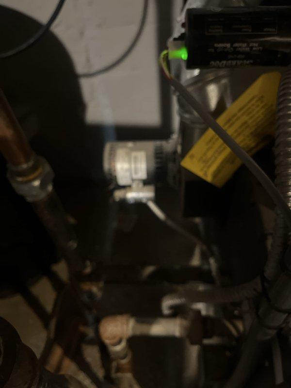 Provided estimate for complete boiler replacement after system failure due to flooding. Evaluated existing Weil-McLain boiler unit with associated piping, valves, and ductwork connections that sustained water damage and is no longer operational. Documented current equipment configuration including copper piping, red isolation valves, and mechanical connections to prepare comprehensive replacement proposal.