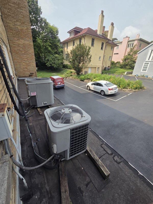 Conducted comprehensive site assessment for commercial HVAC system replacement, evaluating both rooftop condenser units and attic-mounted air handler equipment. Documented existing dual outdoor AC condenser configuration with electrical conduit connections and assessed attic air handler unit with associated flexible ductwork and plenum connections. Provided detailed replacement estimate covering complete HVAC system including outdoor condensing units, indoor air handling equipment, and water heater replacement requirements.