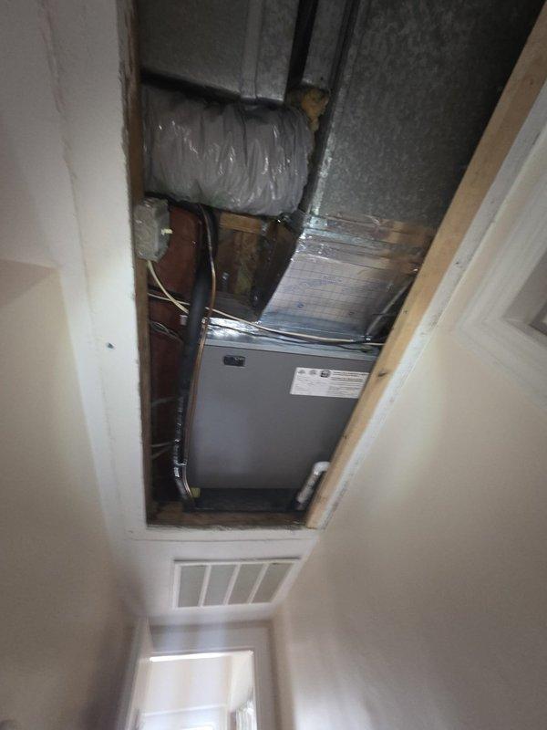 Conducted comprehensive site assessment for commercial HVAC system replacement, evaluating both rooftop condenser units and attic-mounted air handler equipment. Documented existing dual outdoor AC condenser configuration with electrical conduit connections and assessed attic air handler unit with associated flexible ductwork and plenum connections. Provided detailed replacement estimate covering complete HVAC system including outdoor condensing units, indoor air handling equipment, and water heater replacement requirements.