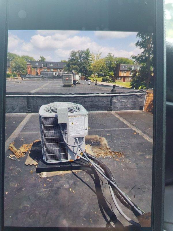 Completed full commercial HVAC system replacement on rooftop installation at multi-unit residential property. Removed existing equipment per EPA specifications and installed Bryant 800SB36070M14 gas furnace, Bryant GA4SAN52400N 2-ton 14 SEER condenser with R-454B refrigerant, and Bryant CVAVA2414XMA evaporator coil. Flushed and reused existing refrigerant lines, fabricated sheet metal transitions to connect to existing supply and return ductwork, and installed return air filter rack. Set new condenser unit on roof pad with outdoor disconnect, whip, and fuses. Utilized crane service for rooftop equipment placement. Completed all electrical connections, verified system operation with clamp meter readings showing proper amperage draw, and obtained required permit. System tested and operational upon completion.