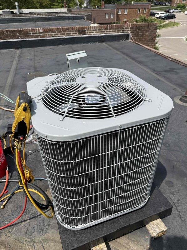 Completed full commercial HVAC system replacement on rooftop installation including Bryant 800SB36070M14 gas furnace, Bryant GA4SAN52400N 2-ton 14 SEER condenser with R-454B refrigerant, and Bryant CVAVA2414XMA evaporator coil. Utilized crane service to safely remove existing equipment per EPA disposal specifications and position new rooftop condenser unit on existing pad with proper leveling and support. Flushed and reused existing refrigerant lines, installed outdoor disconnect with whip and fuses. Fabricated and installed sheet metal ductwork to connect new furnace to existing supply and return plenums, installed return air filter rack for proper filtration. Evacuated refrigerant lines to proper micron level using manifold gauge set, verified system achieved deep vacuum below acceptable threshold. Charged system with R-454B refrigerant to manufacturer specifications, verified proper superheat and subcooling values. Tested all electrical connections, confirmed proper amp draw on cond
