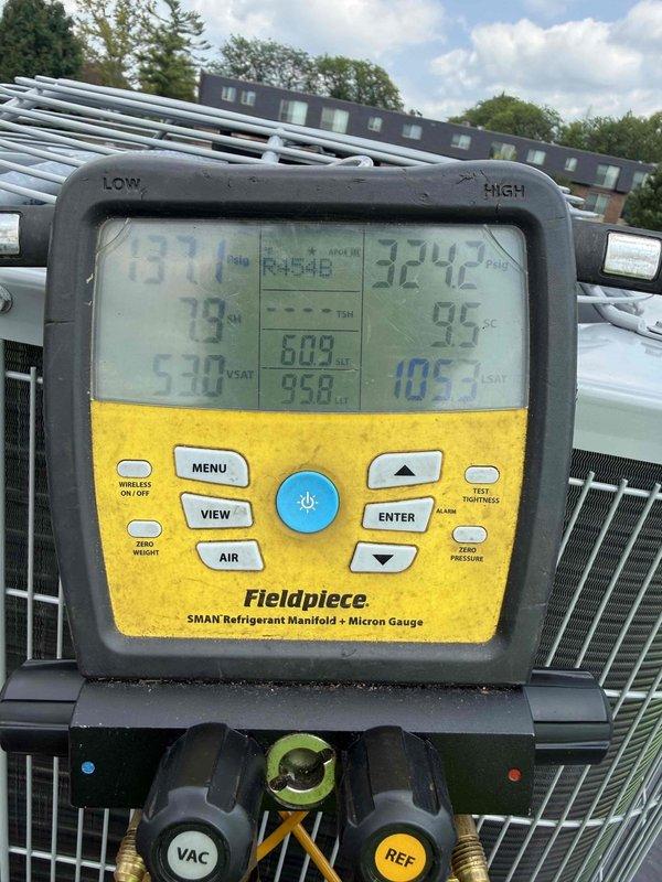 Completed full commercial HVAC system replacement on rooftop installation including Bryant 800SB36070M14 gas furnace, Bryant GA4SAN52400N 2-ton 14 SEER condenser with R-454B refrigerant, and Bryant CVAVA2414XMA evaporator coil. Utilized crane service to safely remove existing equipment per EPA disposal specifications and position new rooftop condenser unit on existing pad with proper leveling and support. Flushed and reused existing refrigerant lines, installed outdoor disconnect with whip and fuses. Fabricated and installed sheet metal ductwork to connect new furnace to existing supply and return plenums, installed return air filter rack for proper filtration. Evacuated refrigerant lines to proper micron level using manifold gauge set, verified system achieved deep vacuum below acceptable threshold. Charged system with R-454B refrigerant to manufacturer specifications, verified proper superheat and subcooling values. Tested all electrical connections, confirmed proper amp draw on cond