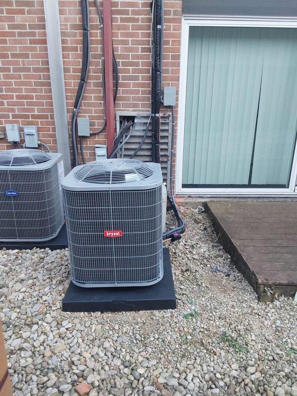 Completed full HVAC system installation for commercial property including Bryant GA4SAN524 air conditioning condensing unit relocated to ground level and BCRMA2124S3N3 water fan coil unit. Installed new refrigerant lineset with proper insulation, ran electrical conduit and wiring along exterior brick wall with junction boxes, and connected copper supply piping to existing water lines with shutoff valves. Positioned both outdoor condensing units on gravel pad with proper clearances, secured all refrigerant lines and electrical connections per manufacturer specifications, installed new programmable thermostat, and completed all work under proper permit. System tested, charged to specifications, and verified operational.