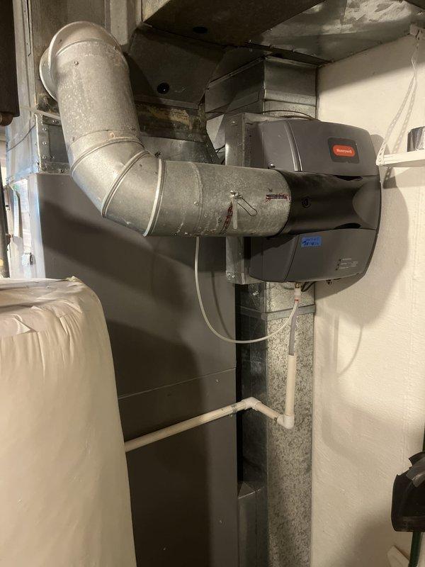 Conducted comprehensive evaluation of existing HVAC system for replacement estimate. Assessed indoor air handler unit located in basement utility area, documenting current furnace configuration with connected metal ductwork and PVC condensate drain line. Evaluated outdoor condenser unit showing significant age-related deterioration, with accumulated dirt and debris on coil surfaces and protective grille. Provided replacement recommendations for complete system upgrade based on observed equipment condition and operational efficiency requirements.