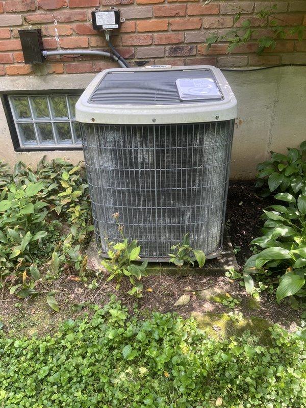 Conducted comprehensive evaluation of existing HVAC system for replacement estimate. Assessed indoor air handler unit located in basement utility area, documenting current furnace configuration with connected metal ductwork and PVC condensate drain line. Evaluated outdoor condenser unit showing significant age-related deterioration, with accumulated dirt and debris on coil surfaces and protective grille. Provided replacement recommendations for complete system upgrade based on observed equipment condition and operational efficiency requirements.