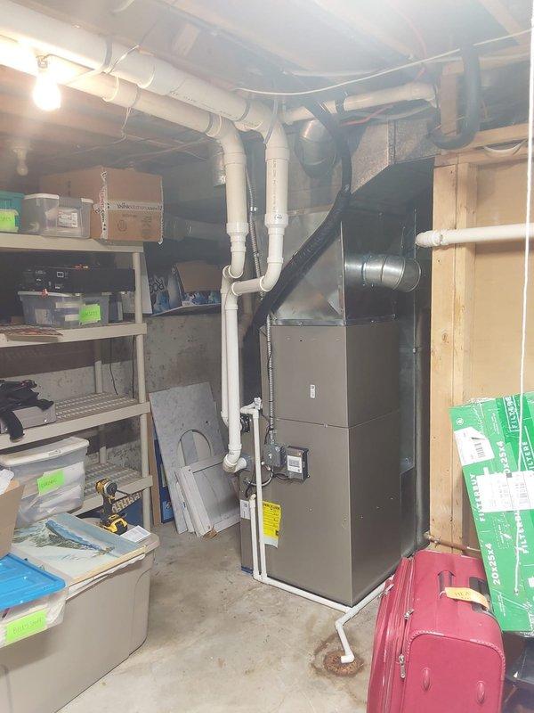 Completed full HVAC system replacement including installation of Bryant 927TA60080V21 Preferred Series gas furnace, CVAVA4221XMA V-coil cased vertical evaporator coil, and 135SAN04200W 3.5-ton single-stage air conditioner utilizing R454B refrigerant. Installed ECOBEE 3 with Intelisense Lite Pro WiFi thermostat for enhanced system control and Bryant 20x25x4 media filter kit for improved air quality. Replaced outdoor unit pad, electrical whip, disconnect, and fuse to meet current electrical code requirements. Cleaned and reused existing refrigerant line set to maintain system efficiency. Removed and properly disposed of all old equipment, leaving basement utility area and exterior installation site clean and operational.