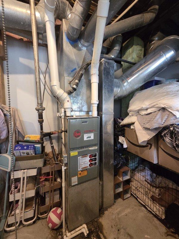 Conducted comprehensive estimate for HVAC system replacement at residential property. Evaluated existing Rheem furnace installation and assessed customer's interest in mini-split system options as alternative or supplemental cooling solution. Documented current thermostat control board with battery backup system and photographed basement mechanical room layout including ductwork configuration to provide accurate replacement recommendations.