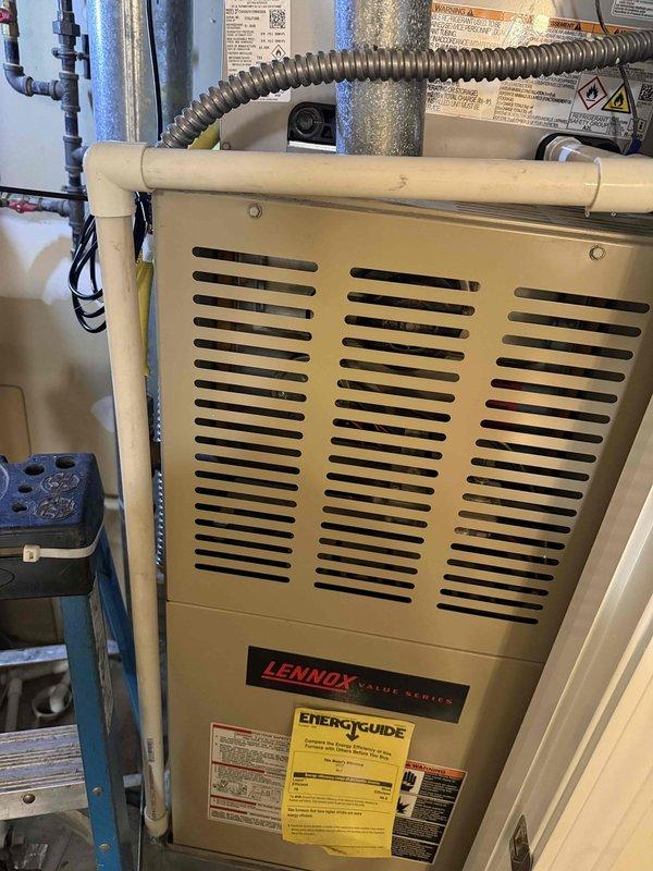 Completed commercial HVAC installation including a Bryant GA4SAN52400N 2-ton 14 SEER condenser utilizing R-454B refrigerant and CVAVA2417 evaporator coil. Flushed and reused existing refrigerant line set, fabricated and installed custom sheet metal transitions to connect new coil to existing supply and return ductwork at the Lennox furnace location. Installed outdoor disconnect with whip, pad, and fuses for the new condenser unit positioned on concrete pad against exterior brick wall. All work completed to code with proper permitting.