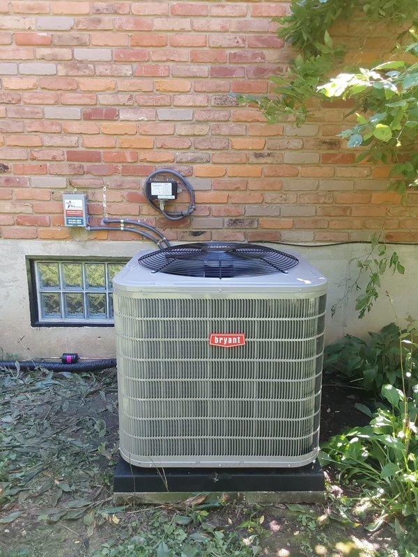Completed full HVAC system replacement including installation of Bryant 927TA60080V21 Preferred series gas furnace, Bryant 148TAN 3-ton two-stage air conditioner utilizing R454B refrigerant, and CVAVA3621XMA cased vertical V-coil evaporator coil in basement mechanical room. Installed Honeywell T6 Pro programmable thermostat for system control, set new concrete pad for outdoor condensing unit positioned against exterior foundation wall, and ran new electrical whip with disconnect and fuse protection to outdoor unit. Cleaned and reused existing refrigerant line sets, connected all ductwork to new furnace, and verified proper drainage for condensate system with PVC piping routed to appropriate drain location.