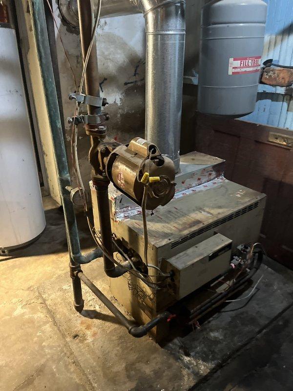 Conducted comprehensive evaluation of existing Lochinvar boiler system including heating load calculations and inspection of current installation configuration. Assessed oil-fired burner assembly, expansion tank, ductwork distribution system, and associated piping connections to determine replacement specifications and system requirements. Documented equipment conditions and spatial constraints in mechanical room to provide accurate recommendations for new boiler installation.