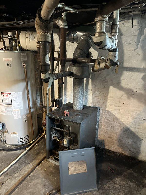 Conducted comprehensive on-site evaluation of aging 1980s-era boiler system and associated hydronic heating components. Documented existing equipment condition, noting significant corrosion on metal piping, deteriorated insulation wrapping on ductwork, and overall system age requiring replacement consideration. Provided detailed estimate for complete boiler system replacement including all necessary connections, venting, and integration with existing water heater and distribution piping.