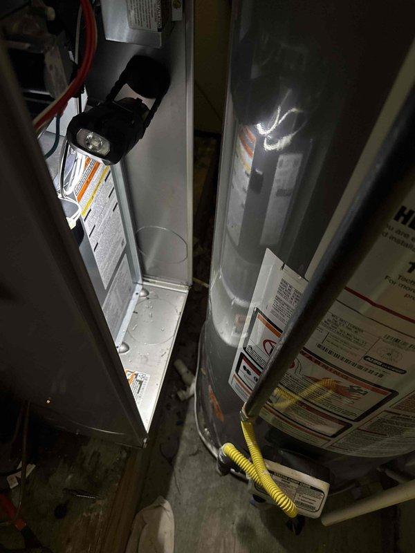 Completed full HVAC system replacement in commercial application, installing Bryant 2-ton 14 SEER condensing unit (model GA4SAN52400N), Bryant evaporator coil (model CVAVA2414), and Bryant 80% efficiency gas furnace (model 800SB36070) in confined utility space. Flushed refrigerant lines and fabricated custom sheet metal transitions to connect new equipment to existing ductwork supply and return plenums. Installed electrical disconnect, whip connection, and verified proper 208/230V power supply to condensing unit. Removed and disposed of existing HVAC equipment in accordance with EPA refrigerant recovery regulations. Obtained necessary permit for installation and completed work to code specifications.