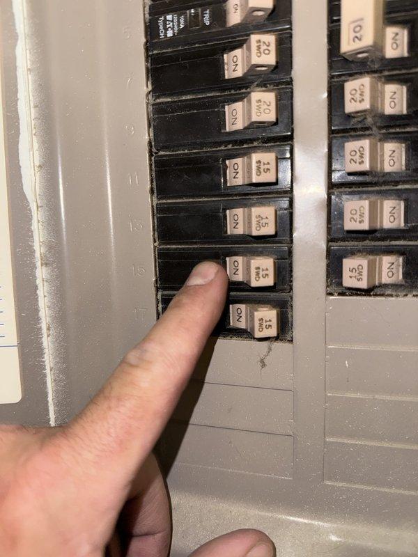 Responded to no cooling call at commercial property. Inspected electrical panel and verified circuit breaker positions and amperage ratings for HVAC system. Examined dual outdoor condenser units positioned on concrete pad adjacent to building, checking both units for operational status and visible issues. Documented equipment condition and electrical supply components including disconnect box mounted on exterior wall.