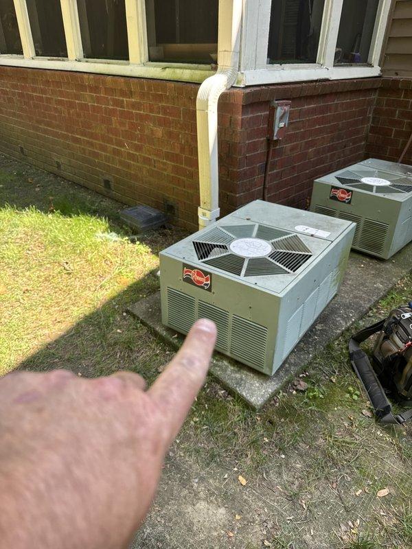 Responded to no cooling call at commercial property. Inspected electrical panel and verified circuit breaker positions and amperage ratings for HVAC system. Examined dual outdoor condenser units positioned on concrete pad adjacent to building, checking both units for operational status and visible issues. Documented equipment condition and electrical supply components including disconnect box mounted on exterior wall.