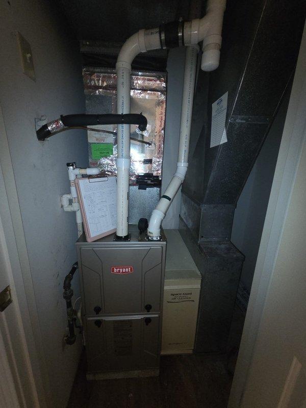 Responded to service call for air conditioning system not keeping up with cooling demand. Upon inspection, confirmed existing system utilizes R22 refrigerant. Documented current HVAC installation including Bryant furnace unit with associated PVC venting and flexible ductwork in mechanical room, along with air handler components. Photographed gas line connections and existing equipment configuration. Provided estimate for complete AC system replacement to address inadequate cooling performance and aging R22-dependent equipment.