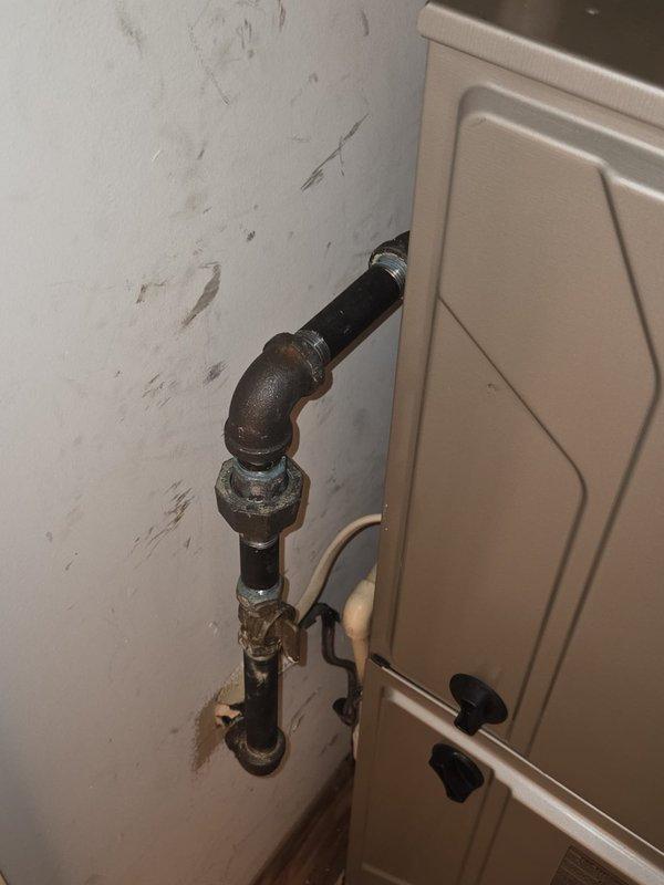 Responded to service call for air conditioning system not keeping up with cooling demand. Upon inspection, confirmed existing system utilizes R22 refrigerant. Documented current HVAC installation including Bryant furnace unit with associated PVC venting and flexible ductwork in mechanical room, along with air handler components. Photographed gas line connections and existing equipment configuration. Provided estimate for complete AC system replacement to address inadequate cooling performance and aging R22-dependent equipment.