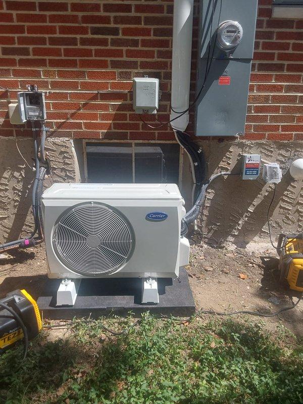Completed full HVAC system installation including a Carrier 927TA48060V17 Preferred series gas furnace, Carrier 148TAN02400W 2.0-ton two-stage air conditioner with R454B refrigerant, and R454BCVAVA2417XMA V-coil cased vertical evaporator coil. Additionally installed a single-zone ductless mini-split system consisting of 37MAHAQ09AA3 outdoor condensing unit and D5MAHAQ09XA3 high-wall indoor air handler. Relocated existing duct run one joist over and repositioned register as requested, with final placement determined on-site for optimal airflow. Mounted outdoor condenser unit on concrete pad against brick foundation, ran insulated refrigerant line sets to both conventional and ductless systems, installed electrical disconnect and completed all wiring connections to existing meter base. System startup performed with electrical verification showing 365-volt reading, all equipment tested and operating within manufacturer specifications.