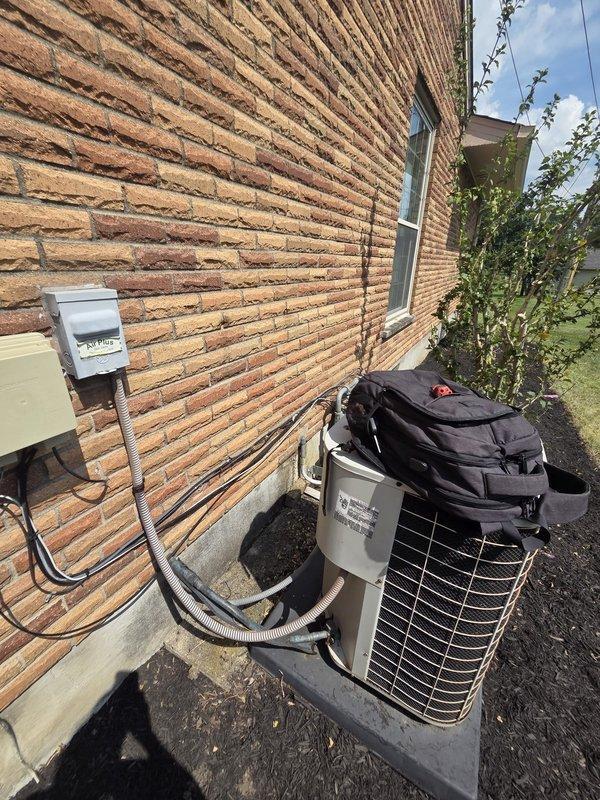 Conducted comprehensive site evaluation for complete HVAC system replacement. Assessed existing outdoor condenser unit and indoor thermostat configuration. Documented current system specifications including ecobee thermostat with power extender kit (PEK) wiring, multi-stage heating and cooling connections, and outdoor condensing unit with electrical disconnect. Photographed equipment placement, refrigerant line routing through exterior brick wall, and existing pad location. Provided customer with replacement options and system recommendations based on current installation parameters.