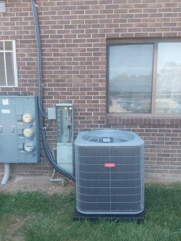 Removed existing through-wall HVAC unit and completed full system replacement with Bryant GA5SAN52400 2-ton 15 SEER air conditioning condenser utilizing R454B refrigerant, relocated and installed on ground-level concrete pad. Installed Bryant FMA5X24 air handler with 5kW heat strip in interior utility closet. Fabricated and installed custom sheet metal transitions to connect new air handler to existing supply and return ductwork. Flushed existing lineset to remove contaminants and ensure system compatibility with new R454B refrigerant. Installed electrical disconnect, whip, and fuses to provide proper power supply and overcurrent protection for outdoor condenser unit. Mounted condenser on equipment pad per manufacturer specifications. Pulled permit for installation and ensured all work met local building codes and manufacturer requirements. Properly recovered refrigerant from old equipment and disposed of existing system components in accordance with EPA regulations. System startup com