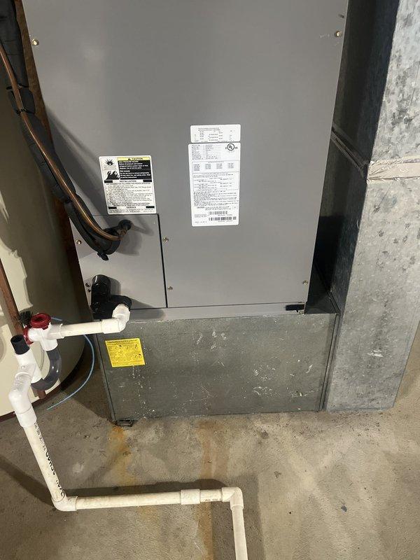 Conducted on-site evaluation of existing air conditioning system for replacement estimate. Assessed current air handler unit located in basement utility area, noting existing refrigerant line configuration, electrical panel capacity and breaker availability, condensate drainage system with PVC piping, and overall installation conditions. Documented equipment specifications, mounting location against concrete wall, and utility connections to provide comprehensive replacement options and system sizing recommendations.