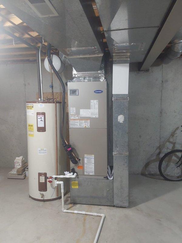 Completed full HVAC system replacement including installation of 235SAN03600A Legacy 3.0 ton heat pump with R454B refrigerant and FT5ANXC36L00 fan coil unit in basement. Installed TU-EC-15BKB 15kW heat kit for auxiliary heating. Replaced existing pole-mounted outdoor unit with new pad and pump-up installation due to width incompatibility (existing poles 37 inches apart, new unit 31 inches wide). Installed new electrical whip, disconnect box with fuses, and refrigerant line set connecting outdoor condenser to indoor air handler. Removed and properly disposed of old heat pump system. All electrical connections completed to code, system charged, tested, and verified operational.
