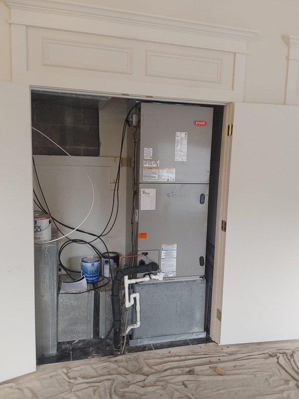 Completed commercial air conditioning system installation at multi-family residential property. Installed new Bryant 5-ton condensing unit on protective pad with proper clearances from building exterior, mounted on existing mulch bed against brick wall. Installed Bryant 5-ton cooling-only air handler in interior utility closet with all required electrical disconnects, control wiring, and safety labeling. Reused existing refrigerant line set and condensate drain piping, verifying integrity and proper insulation of all connections. Terminated all electrical connections to code specifications with appropriate disconnect switches mounted on exterior wall. System tested for proper operation, refrigerant charge verified, and airflow confirmed within manufacturer specifications. All work performed under permit and inspected per local building codes.