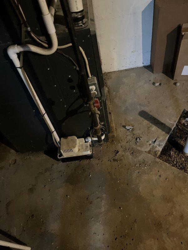 Performed estimate on 9-year-old air conditioning system with failed compressor no longer under warranty. Evaluated equipment condition and repair feasibility in basement utility area, documenting existing HVAC installation including furnace, air handler, and associated ductwork and drainage components. Provided replacement estimate as economical alternative to compressor repair given unit age and out-of-warranty status.