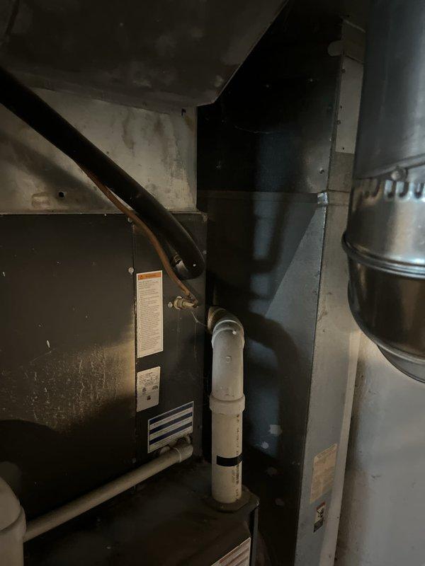 Performed estimate on 9-year-old air conditioning system with failed compressor no longer under warranty. Evaluated equipment condition and repair feasibility in basement utility area, documenting existing HVAC installation including furnace, air handler, and associated ductwork and drainage components. Provided replacement estimate as economical alternative to compressor repair given unit age and out-of-warranty status.