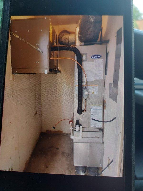 Completed installation of Carrier FJ5ANXA18L00 air handler with 8KW electric heater and NCP5184000 coil in commercial utility closet. Installed refrigerant lines, condensate drain piping, and black flex ductwork connections to unit; original FJ5ANXB24L00 model was not suitable due to space constraints in the mechanical room. System tested and verified operational with proper airflow and refrigerant charge.