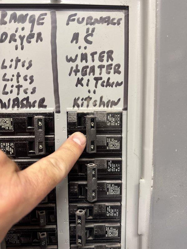 Responded to no cooling complaint at commercial apartment unit. Upon arrival, located HVAC system in utility closet and verified electrical circuit breaker panel for proper power supply to air conditioning system. Inspected breaker labeled for furnace/AC circuit and documented panel configuration for unit troubleshooting.